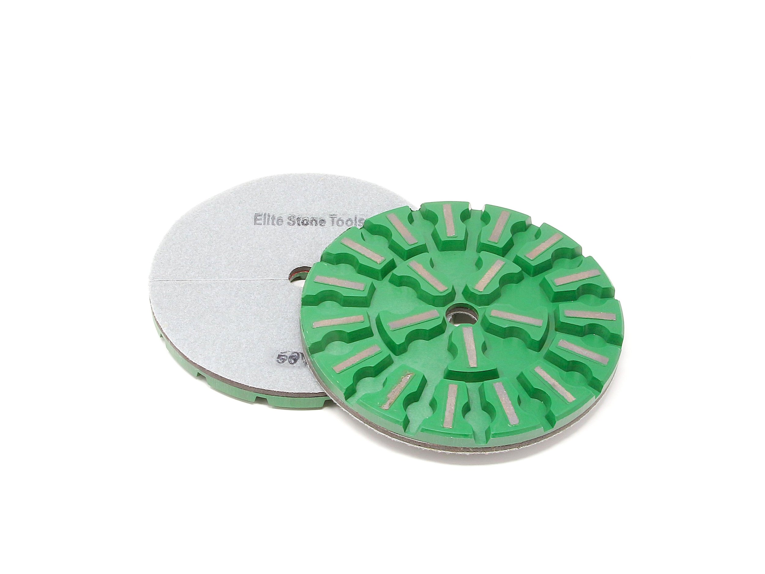 Two diamond grinding wheels, one green with silver diamond segments and one plain with 'Elite Stone Tools' and '500' marked on it, used for sharpening or shaping hard materials.