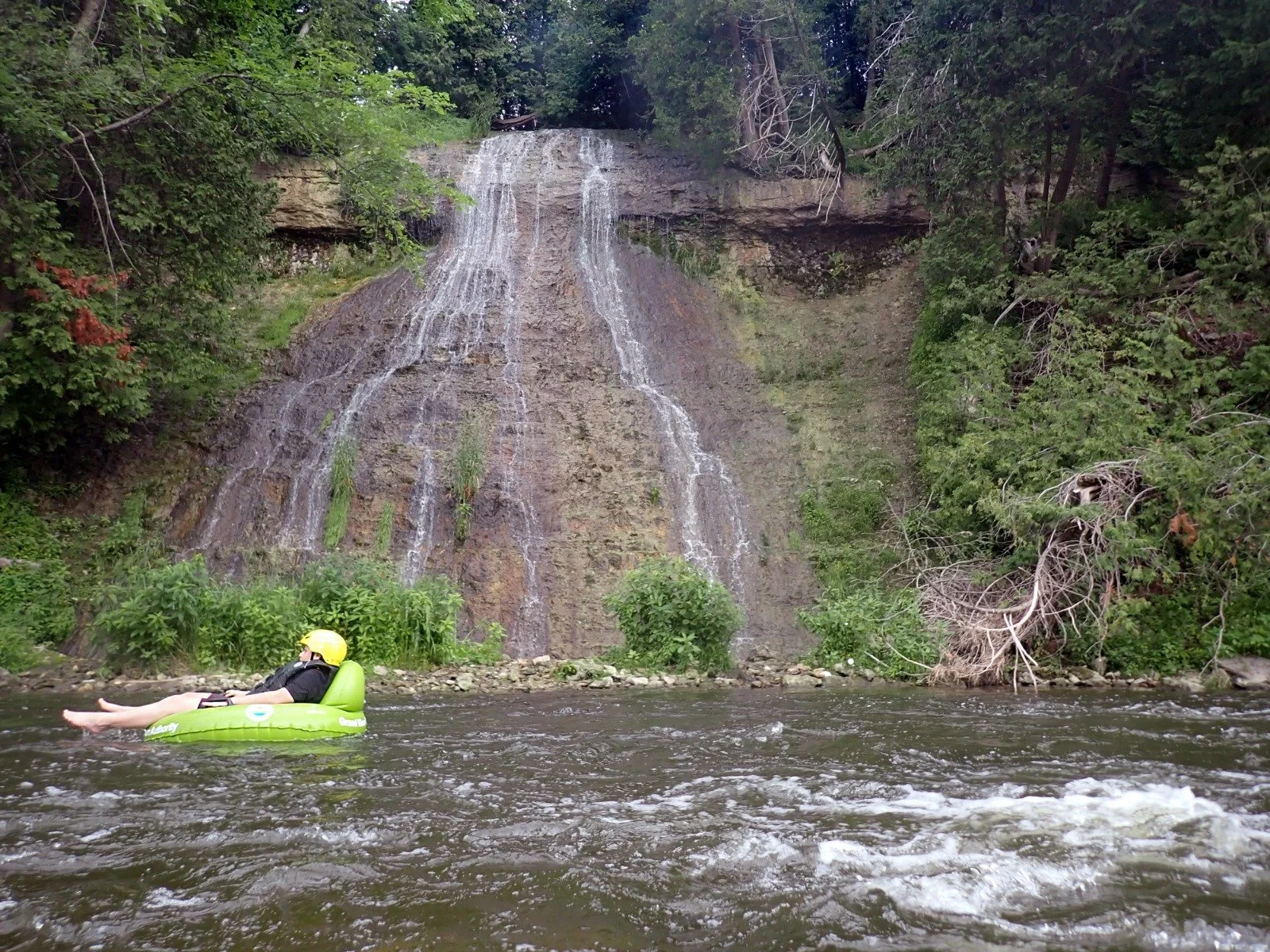 Tuber floats by a waterfall