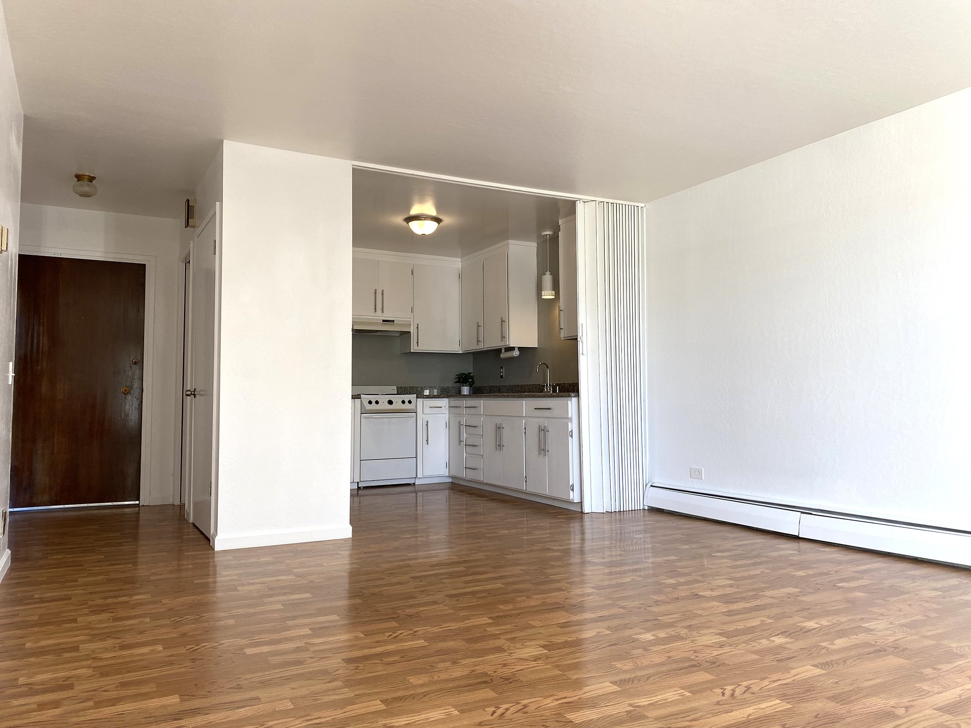 View of entrance, hallway closet, kitchen, & living room