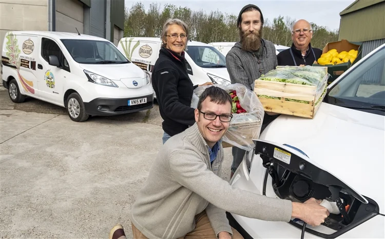Duncan Catchpole from Cambridge Organic Food Company with, from left, Carole Brook, Jack Arnold and Mike Smart - and the firm's branded electric van range. Picture: Keith Heppell, Cambridge Independent.