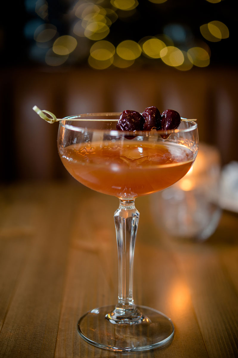 cocktail with cranberry garnish