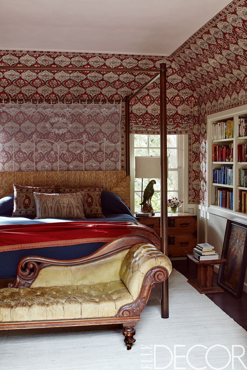 In the master bedroom, the bed by Hollywood at Home is dressed in Deborah Sharpe Linens , the antique George IV settee retains its original leather and the wall covering and shade are of Minnie Maharani by Peter Dunham Textiles .