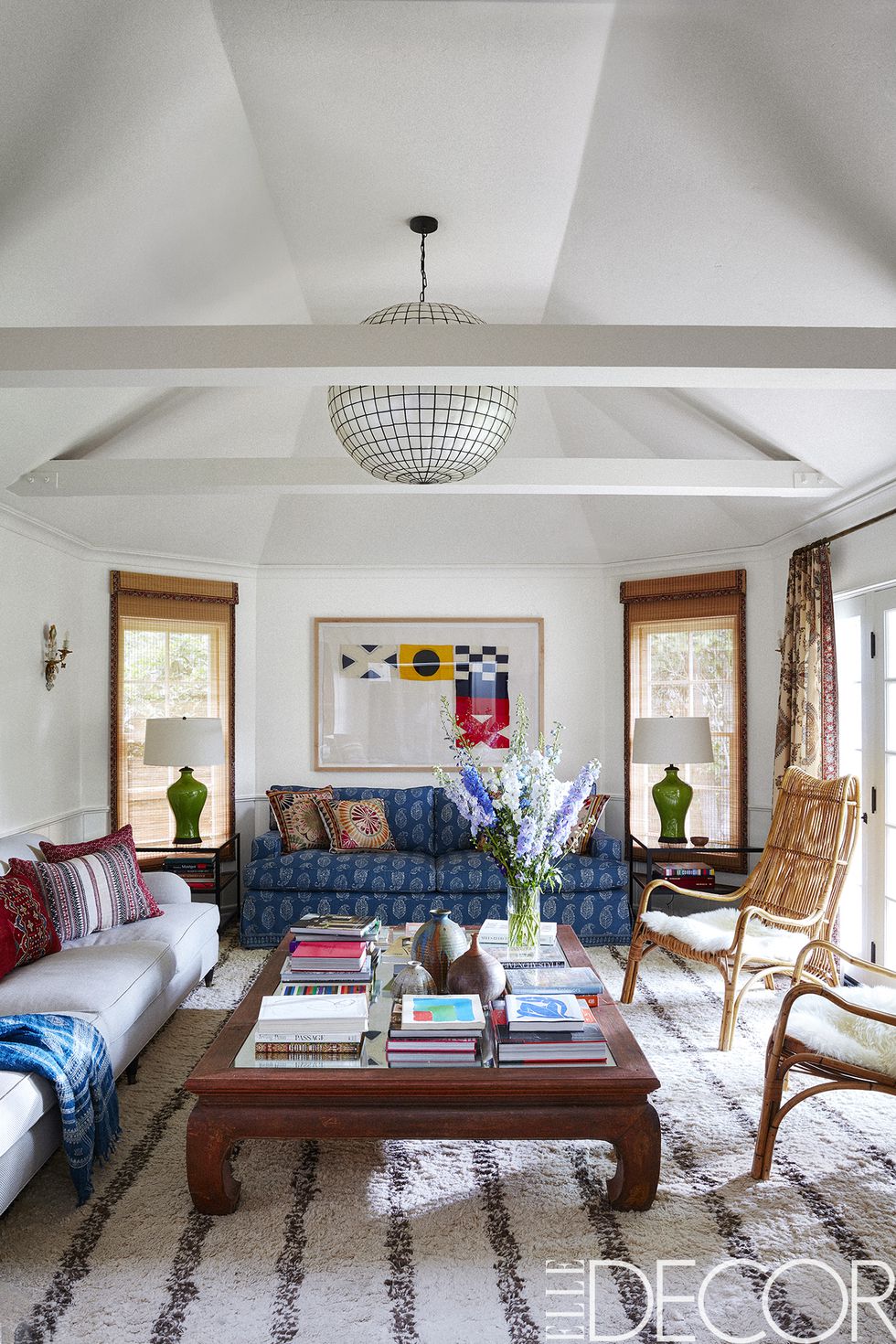 In the family room, the actress’s own artwork hangs over a sofa re-covered in a paisley by Peter Dunham Textiles , a custom sofa is upholstered in a Schumacher performance fabric, the armchairs are from the ’70s and the cocktail table base is from an antique Chinese opium bed. The custom rug is from Dunham’s shop, Hollywood at Home , the pendant light is vintage and the walls are in Benjamin Moore’s Decorator’s White .