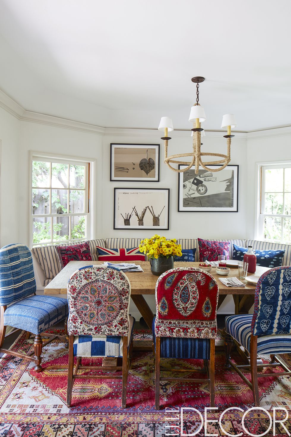The chairs in the dining area came from Driver’s former house and were re-covered in vintage Islamic and African textiles, the banquette is covered in a Pindler stripe, the chandelier is by Hollywood at Home , the vintage rug is from Jamal’s Rug Collection and the watercolors are by Konstantin Kakanias .