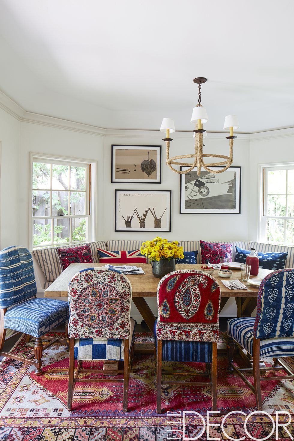 The chairs in the dining area came from Driver’s former house and were re-covered in vintage Islamic and African textiles, the banquette is covered in a Pindler stripe, the chandelier is by    Hollywood at Home   , the vintage rug is from   Jamal’s Rug Collection    and the watercolors are by   Konstantin Kakanias  .
