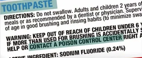 Why does fluoridated toothpaste have a poison warning on the label?