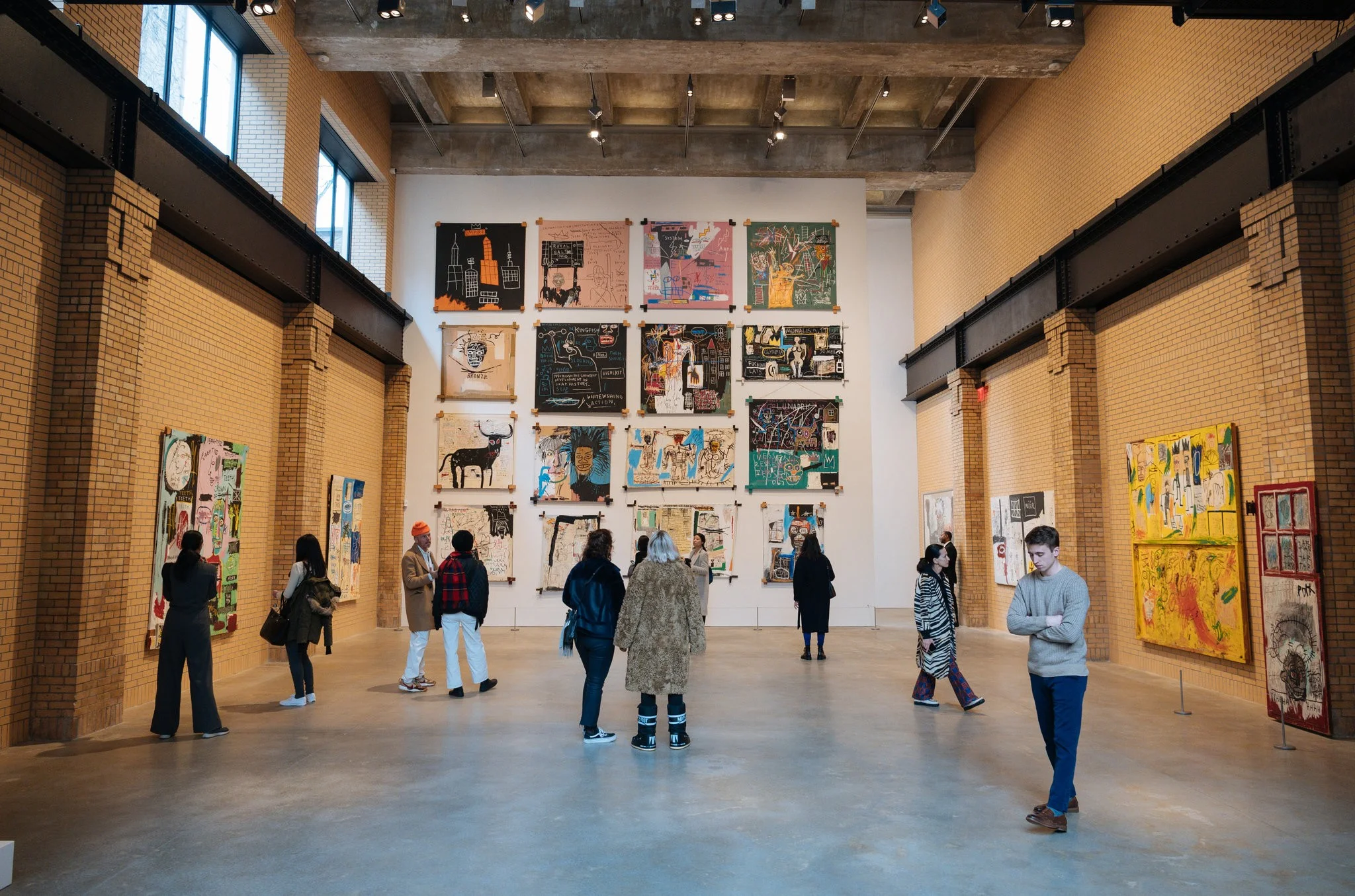 Installation view of “Jean-Michel Basquiat,” the inaugural exhibition of the Brant Foundation’s New York space in the East Village. A salon-style wall on the second floor includes a grid of 16 paintings from 1982.CreditCreditThe Estate of Jean-Michel Basquiat, Licensed by Artestar, New York; via The Brant Foundation; Charlie Rubin for The New York Times