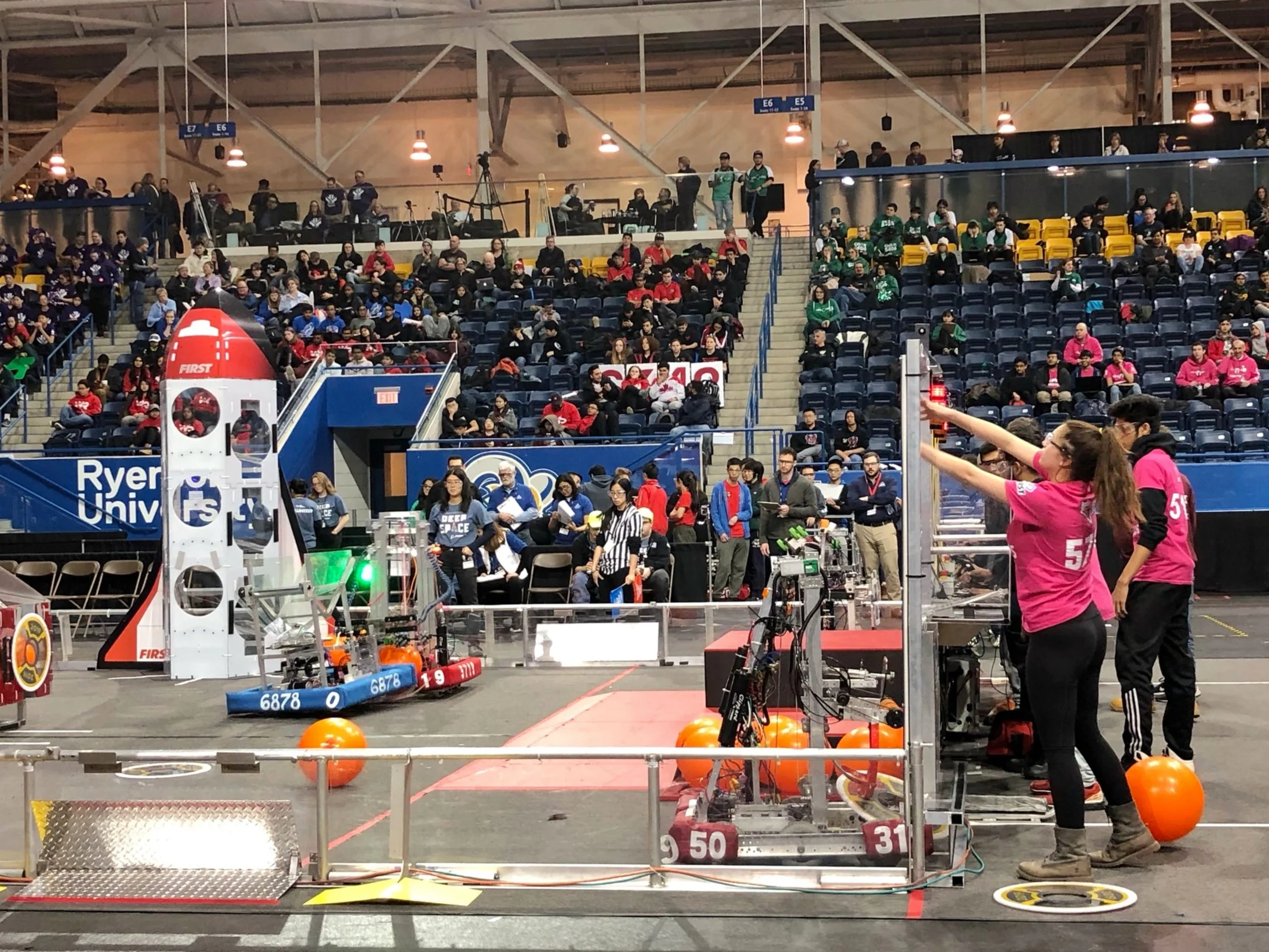 Team 5719 "Pink Titans" load cargo from their alliance station