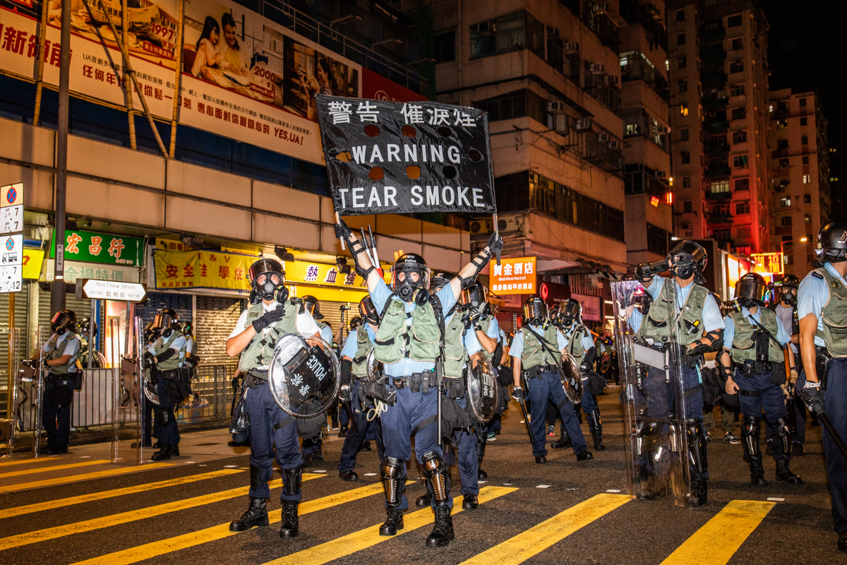 When riot police do this they always remind of ring girls at a boxing match.