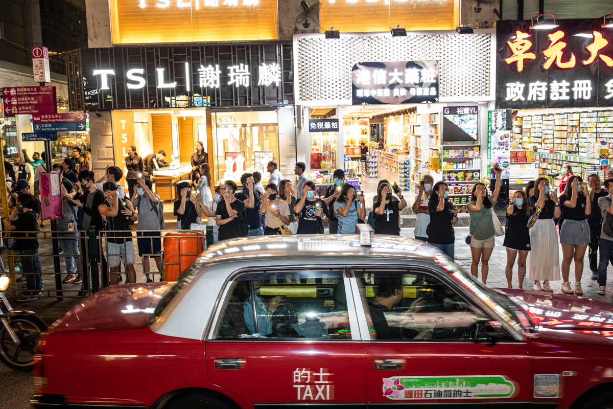 Nathan Rd. - Protestors cover one eye referencing a protestor hit in the eye by a projectile during a previous protest.