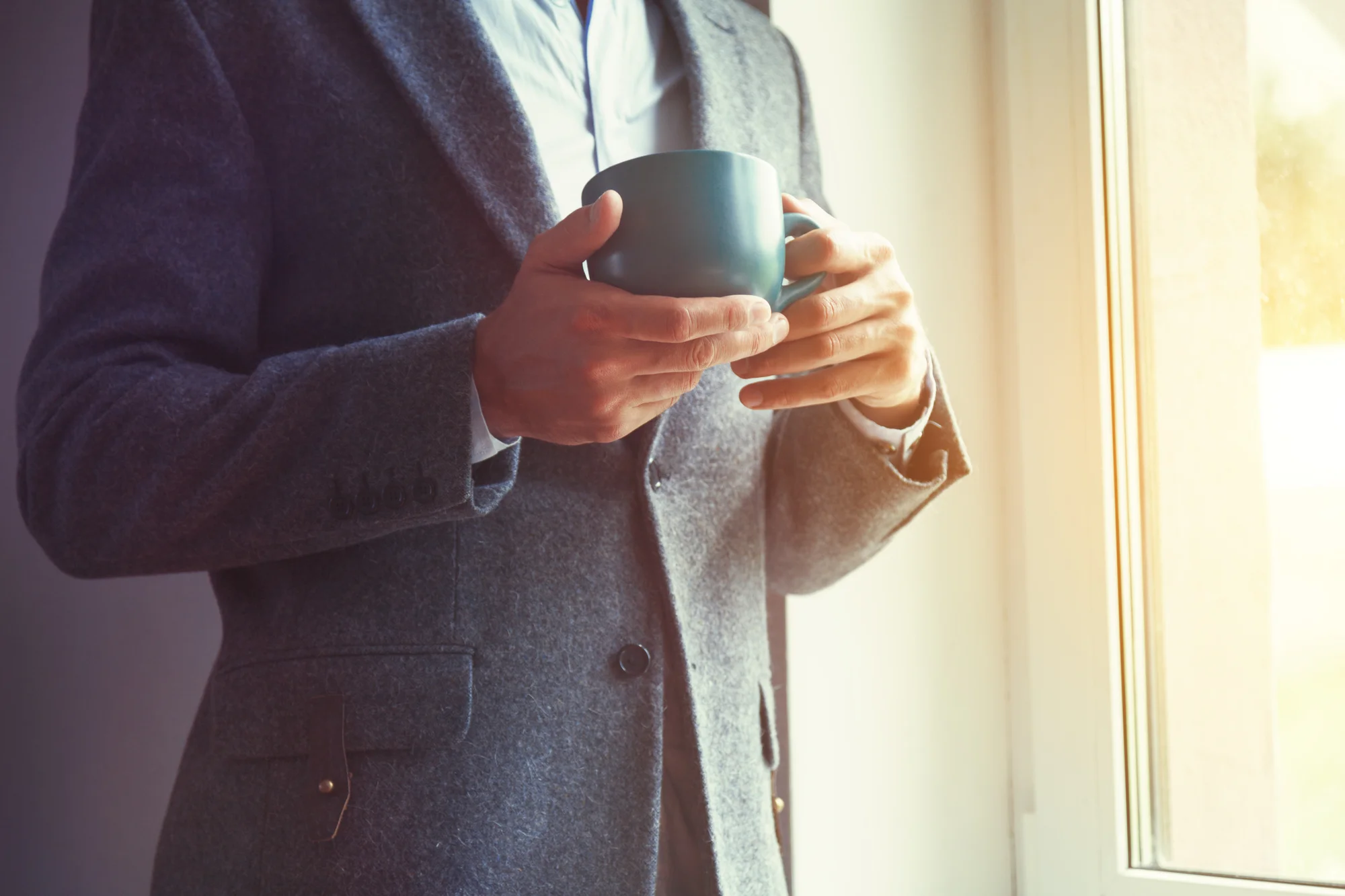 Businessman holding tea.jpg
