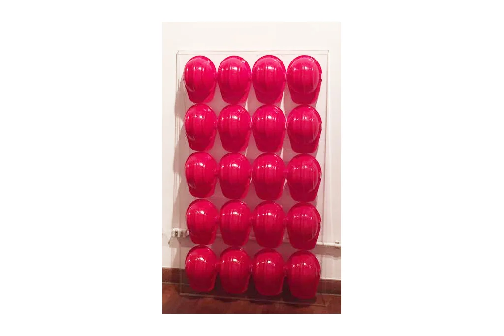 CABEÇA DURA _ objeto, 0,92 x 150 cm, capacetes perfilados sobre base de acrílico.