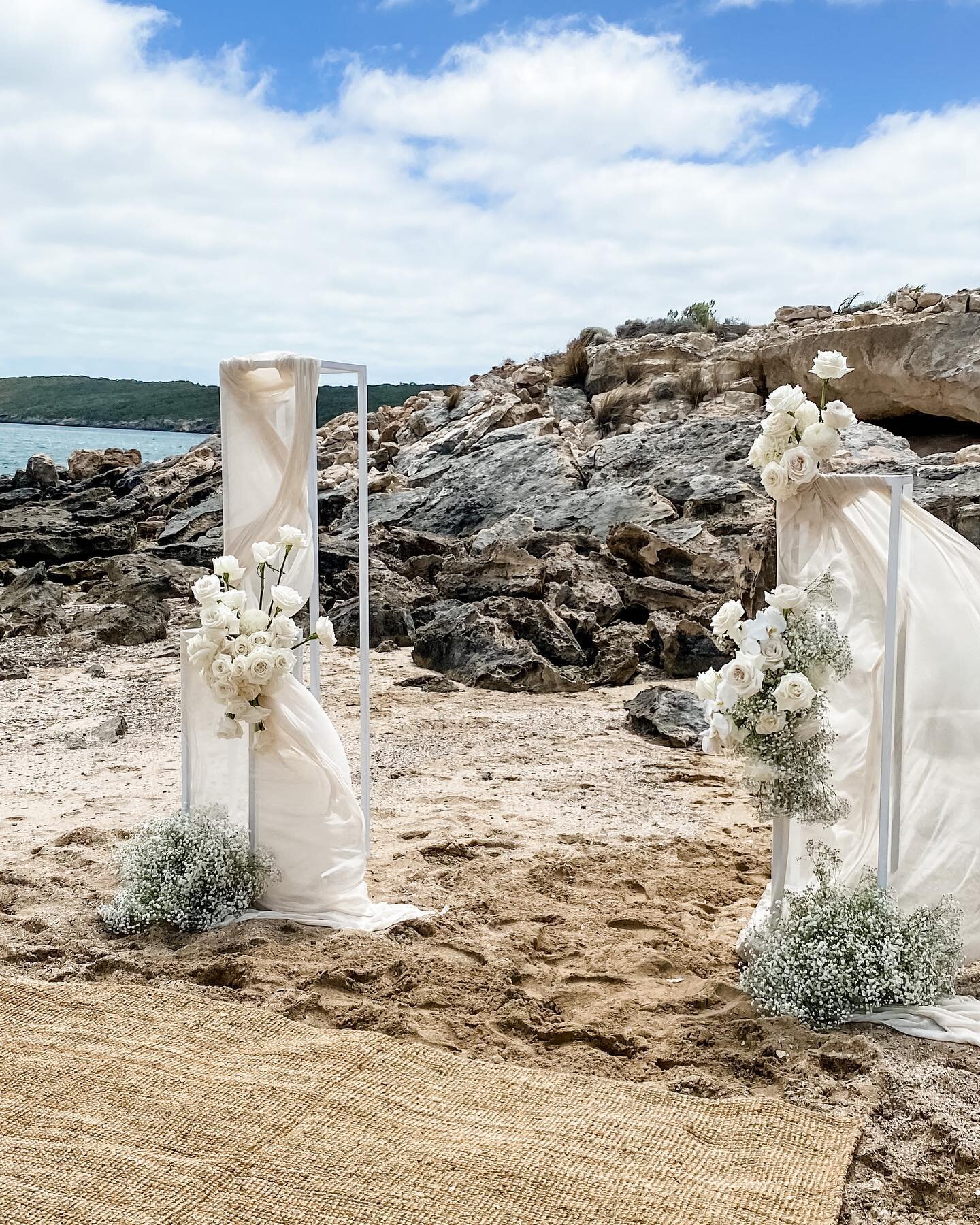 Ceremony florals for Kaitlyn + Brett 🤍 

Full of playa Blanca roses, gypsophila, orchids, chrysanthemums and dahlias. 

The addition of fabric gives that extra little drama to the flowers and worked perfectly with the coastline backdrop.