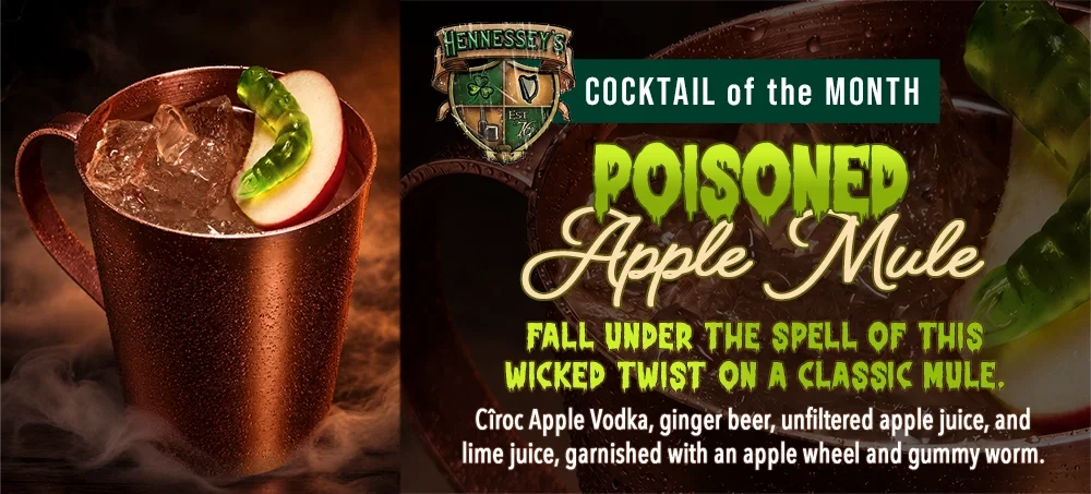 Hennessey’s Poisoned Apple Mule in a copper mug with an apple wheel and green gummy worm, featured as October’s Cocktail of the Month.
