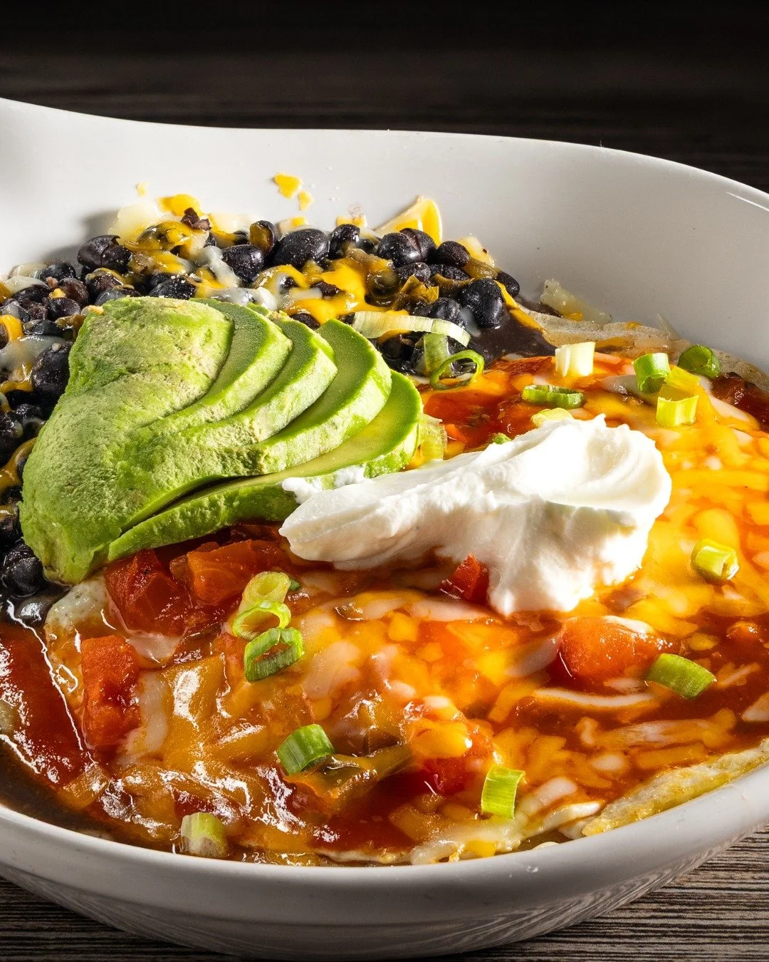 🍳✨Start your day the flavorful way with our Huevos Rancheros! 
Scrambled eggs piled high over black beans on a corn tortilla, topped with fresh salsa, avocado, sour cream, cheese, and your choice of toast or tortillas.
It's bold, it’s satisf