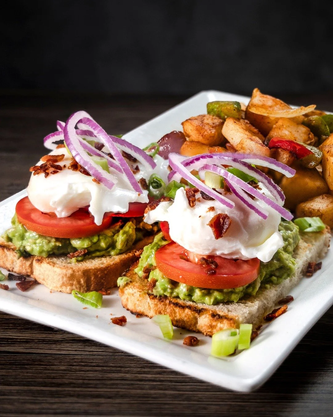 🥑🍞 Avocado Toast at Hennessey’s! 
Sourdough bread topped with smashed avocado, sliced tomato, crispy bacon, 2 poached eggs, pickled onions, and everything seasoning—served with breakfast potatoes.
Don’t miss out on our ✨ Two Tim