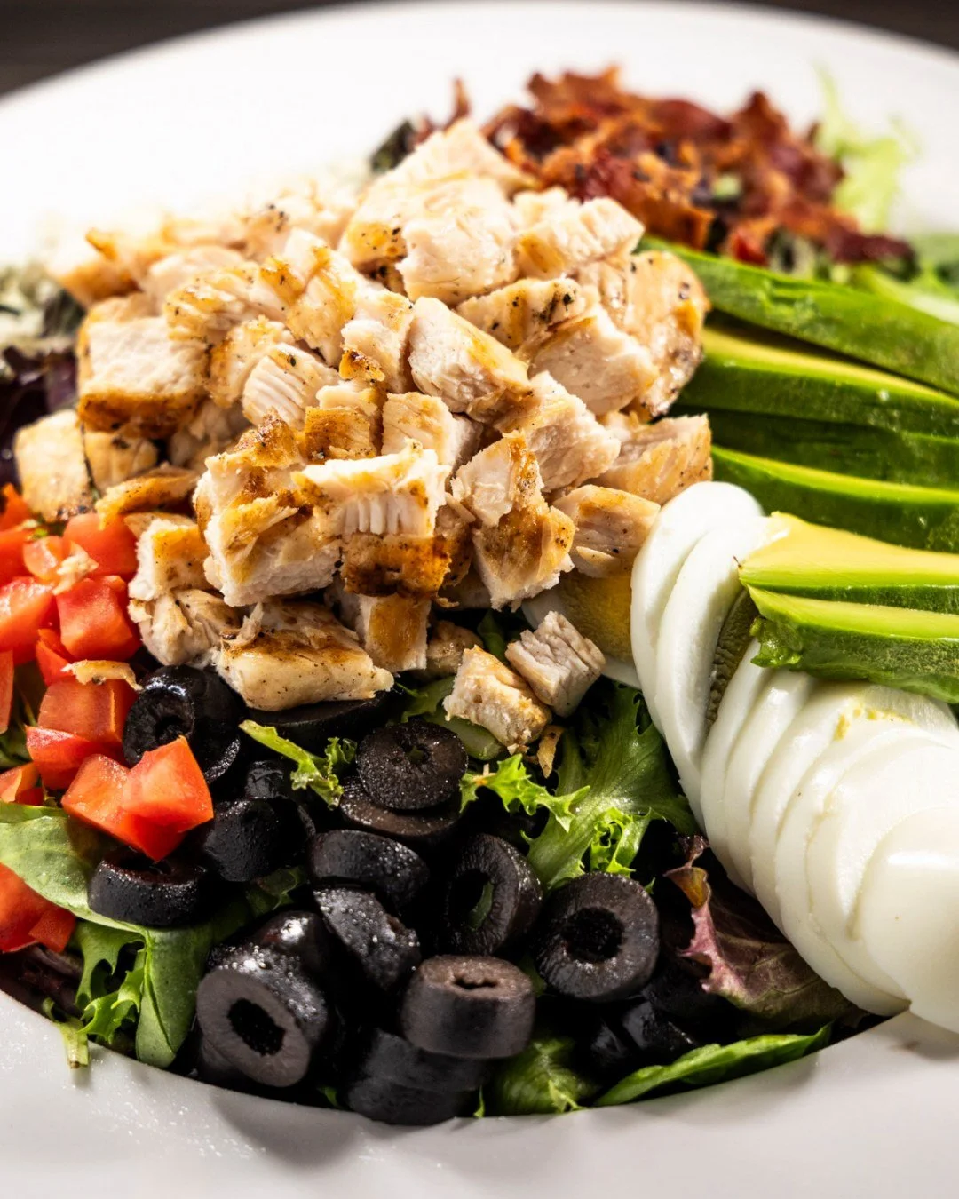 🥗 Freshen up your meal with our H.T. Chicken Cobb Salad! 

A delicious blend of mixed greens, grilled chicken, avocado, crispy bacon, ripe tomatoes, bleu cheese crumbles, black olives, and egg, all topped with your choice of dressing. Nutritious and