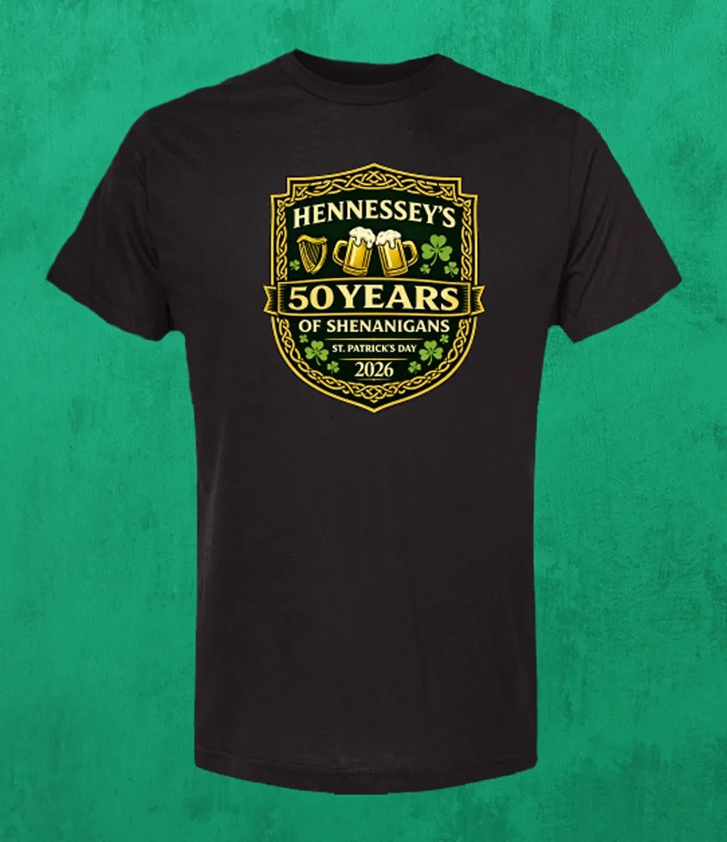 Black men’s T-shirt featuring the Hennessey’s Tavern “50 Years of Shenanigans” St. Patrick’s Day 2026 crest with shamrocks and Irish-themed icons.
