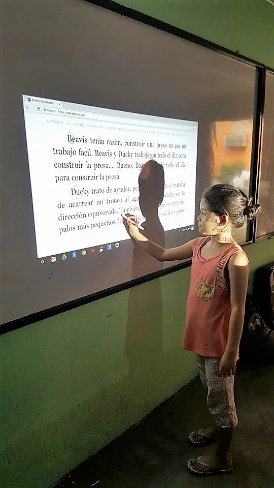 Adding punctuation, and teaching her classmates while learning.