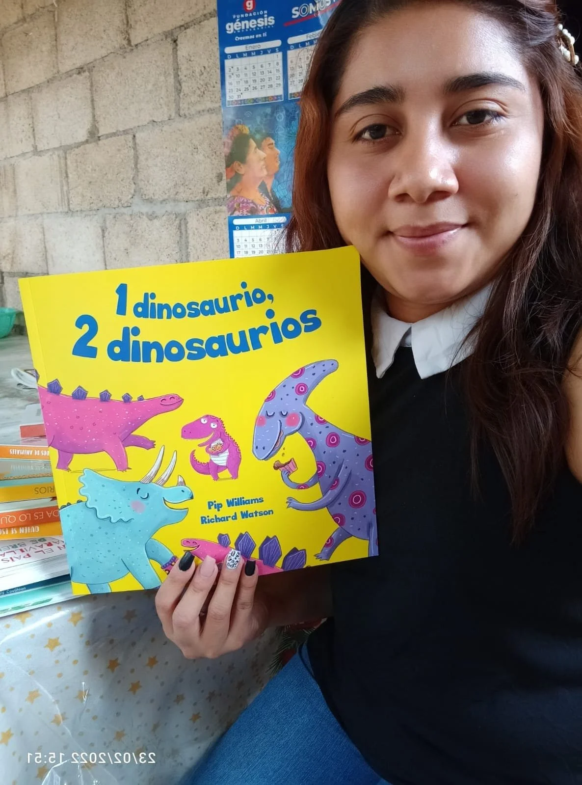 Reina with Dino book.JPG