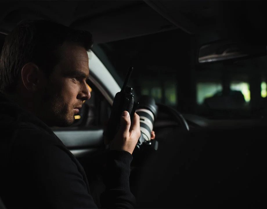 Private investigator conducting discreet surveillance from a vehicle in Manhattan and NYC, NY