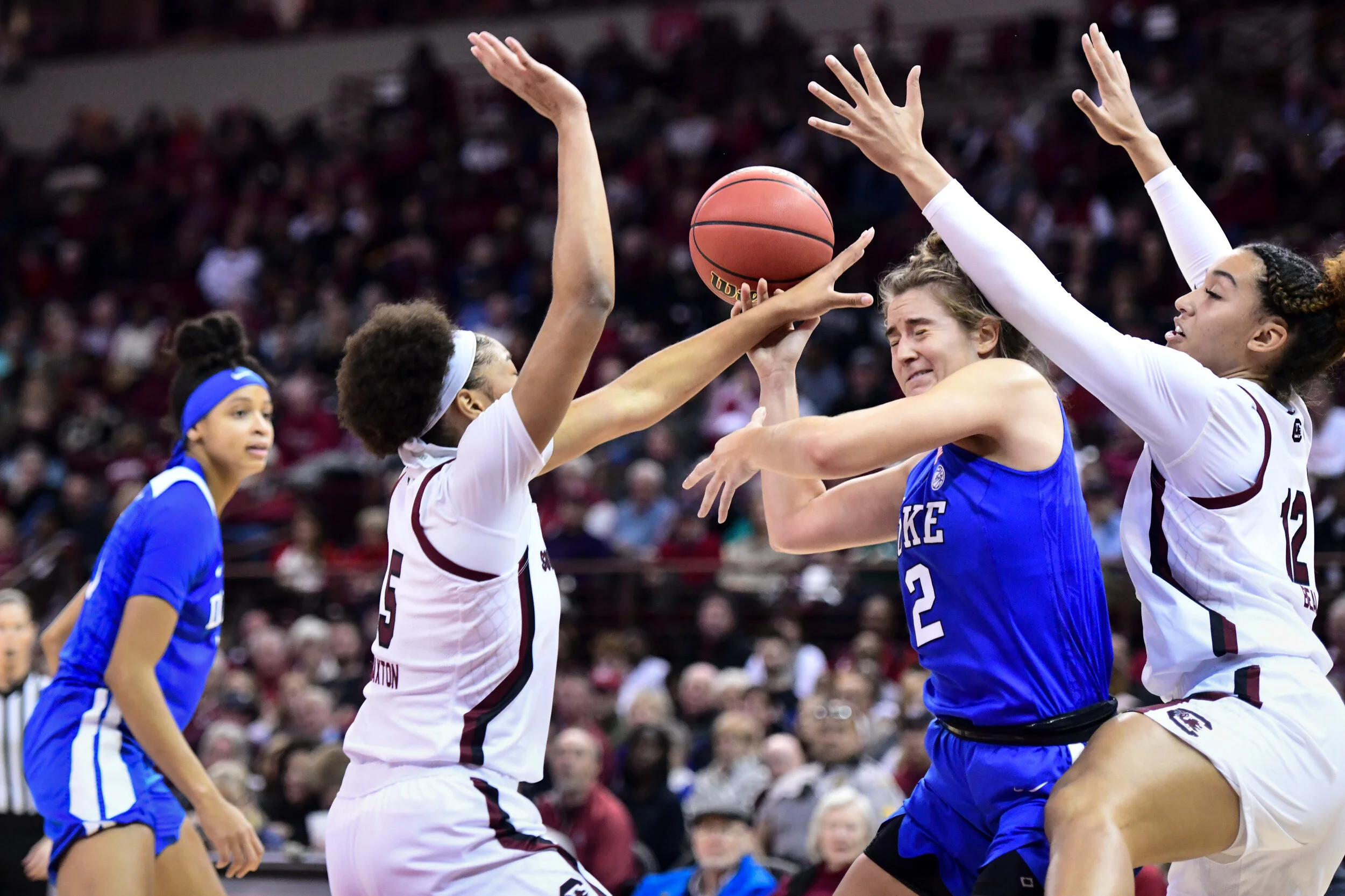 A Duke player is defended by South Carolina players