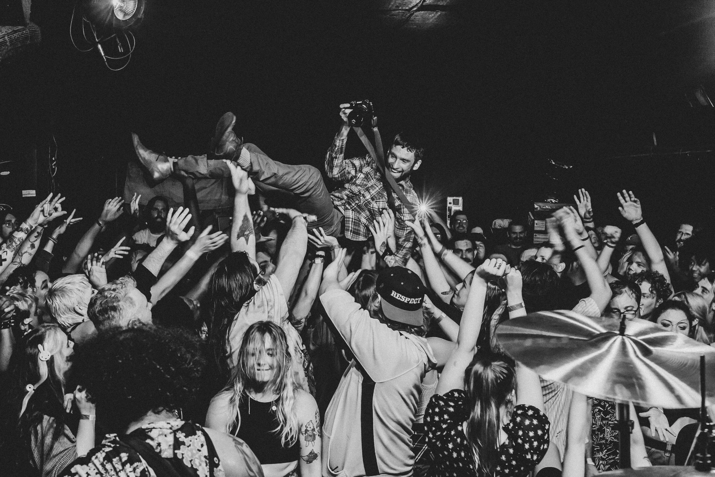 Photography course Instructor Sean Rayford crowd surfs at New Brookland