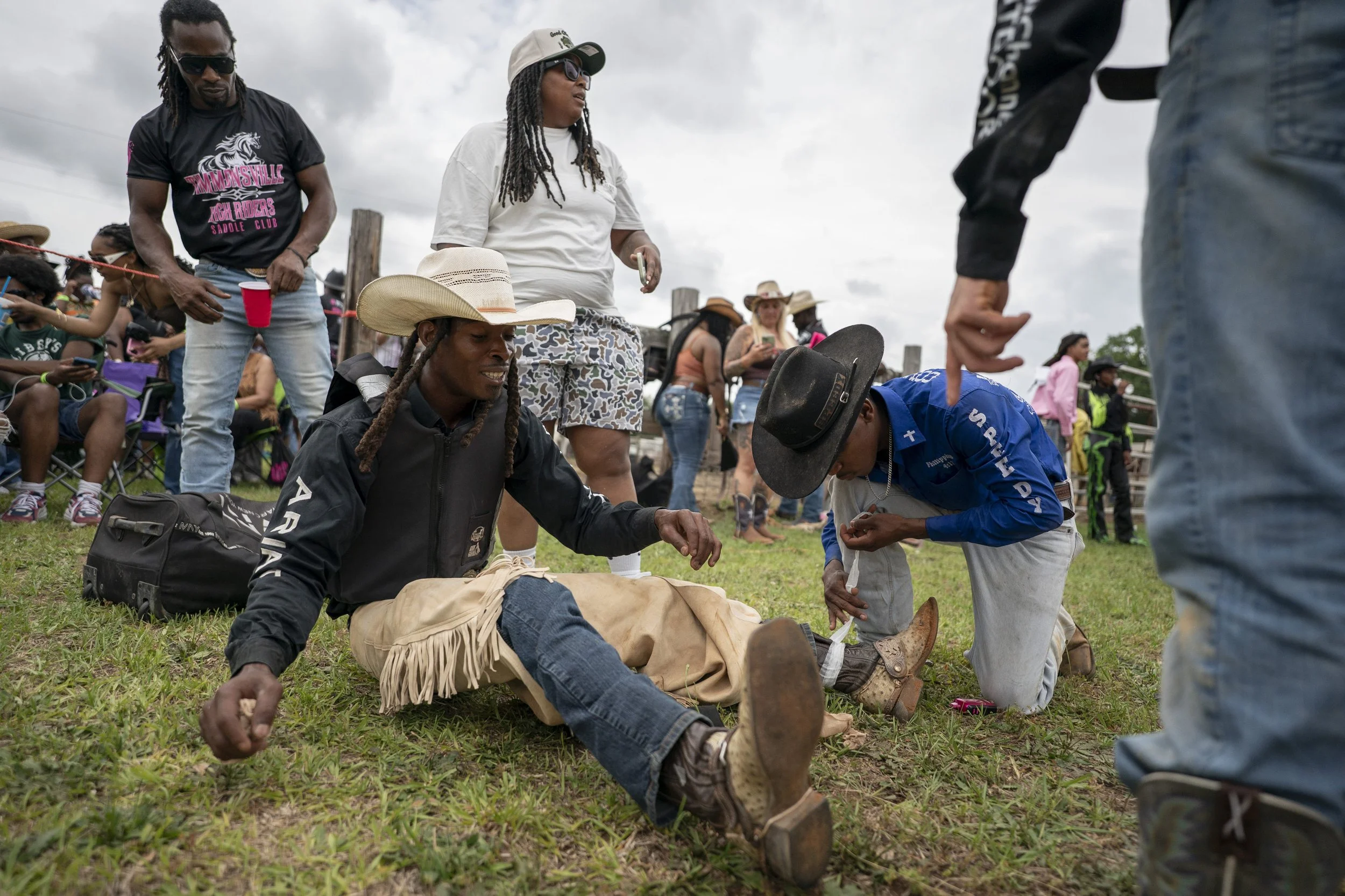 Daniell Brown sits on the ground after a bronc ride