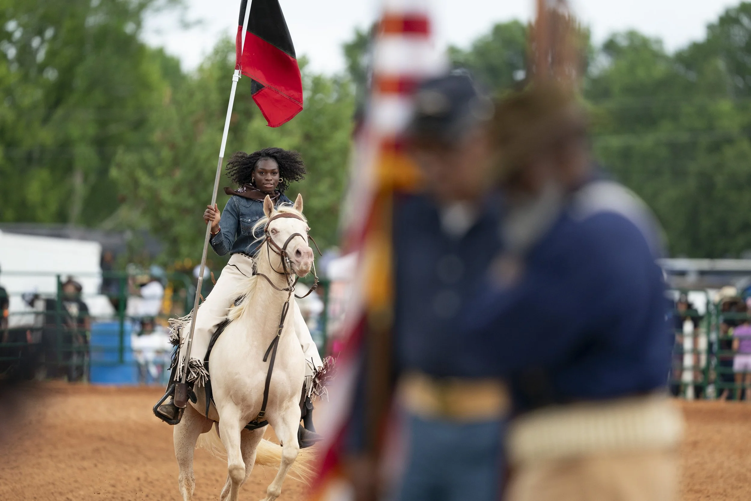 A cowgirl rides in the arena