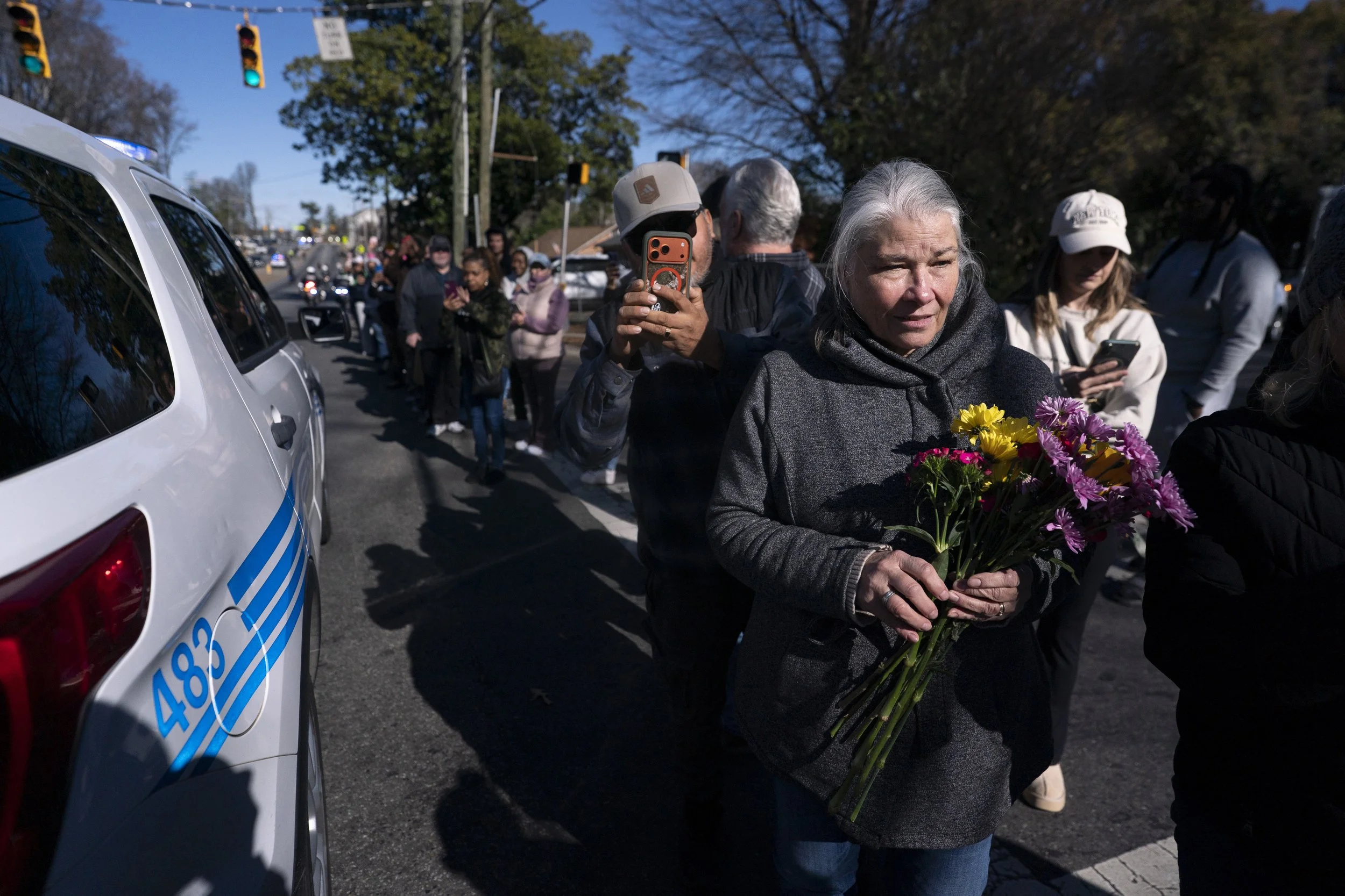 People wait for Buddhist monks continue their Walk for Peace on January 15, 2026 in Charlotte, North Carolina.