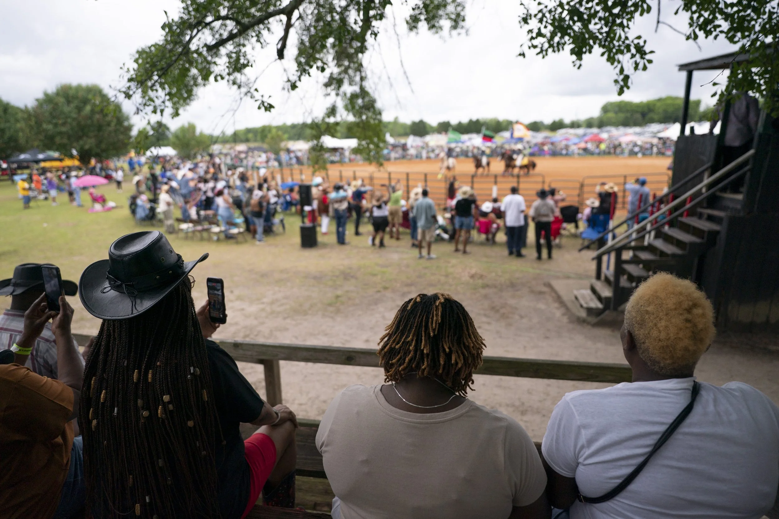 People watch a rodeo from the stands