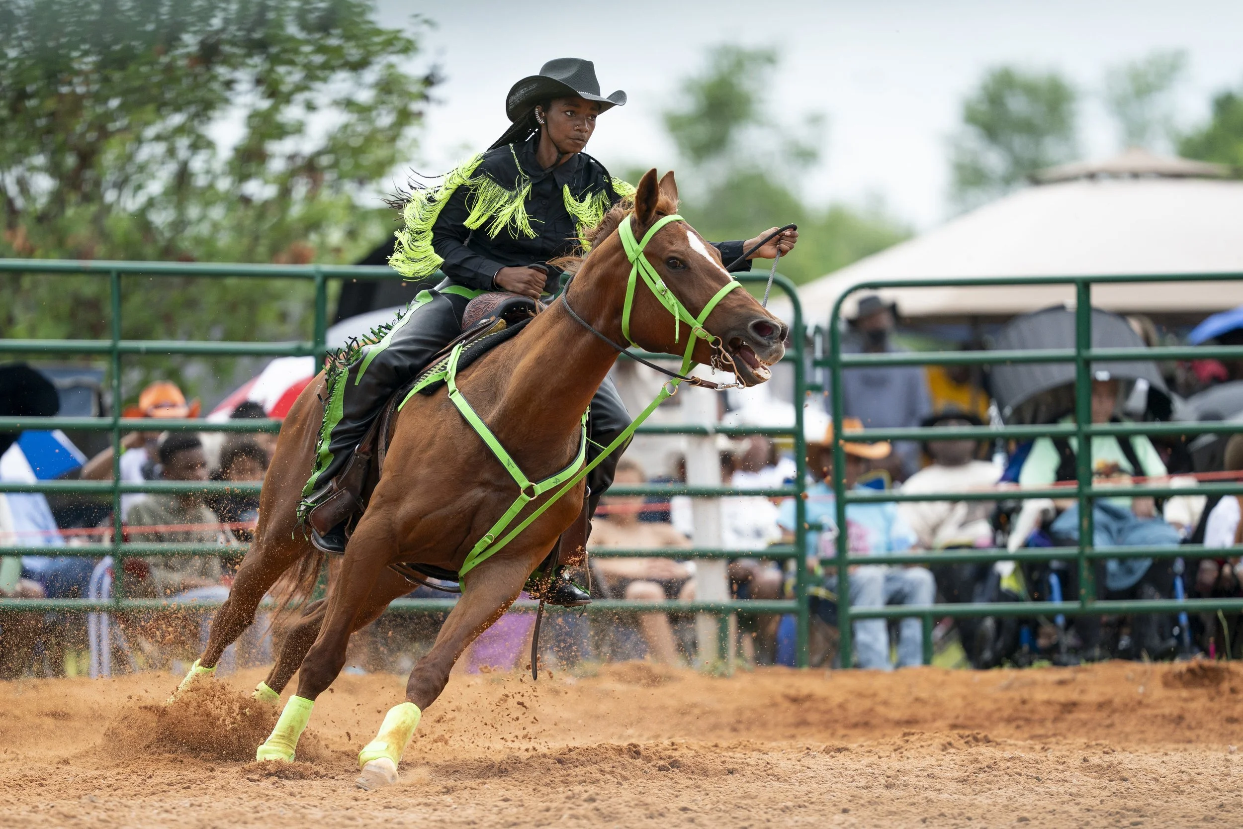 A Cowgirls rides in the arena