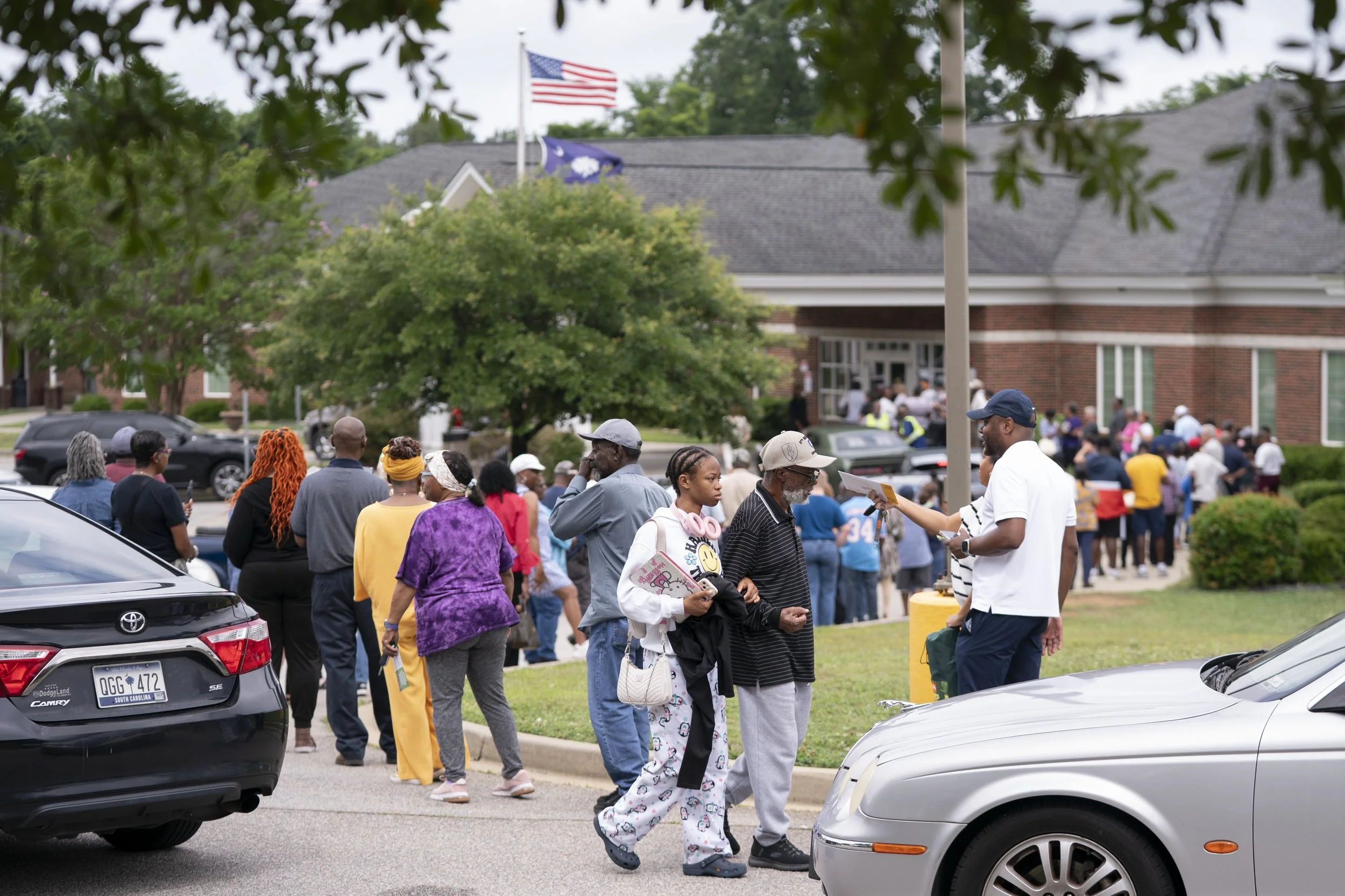 Peole wait in line for early voting on Hopkins, SC