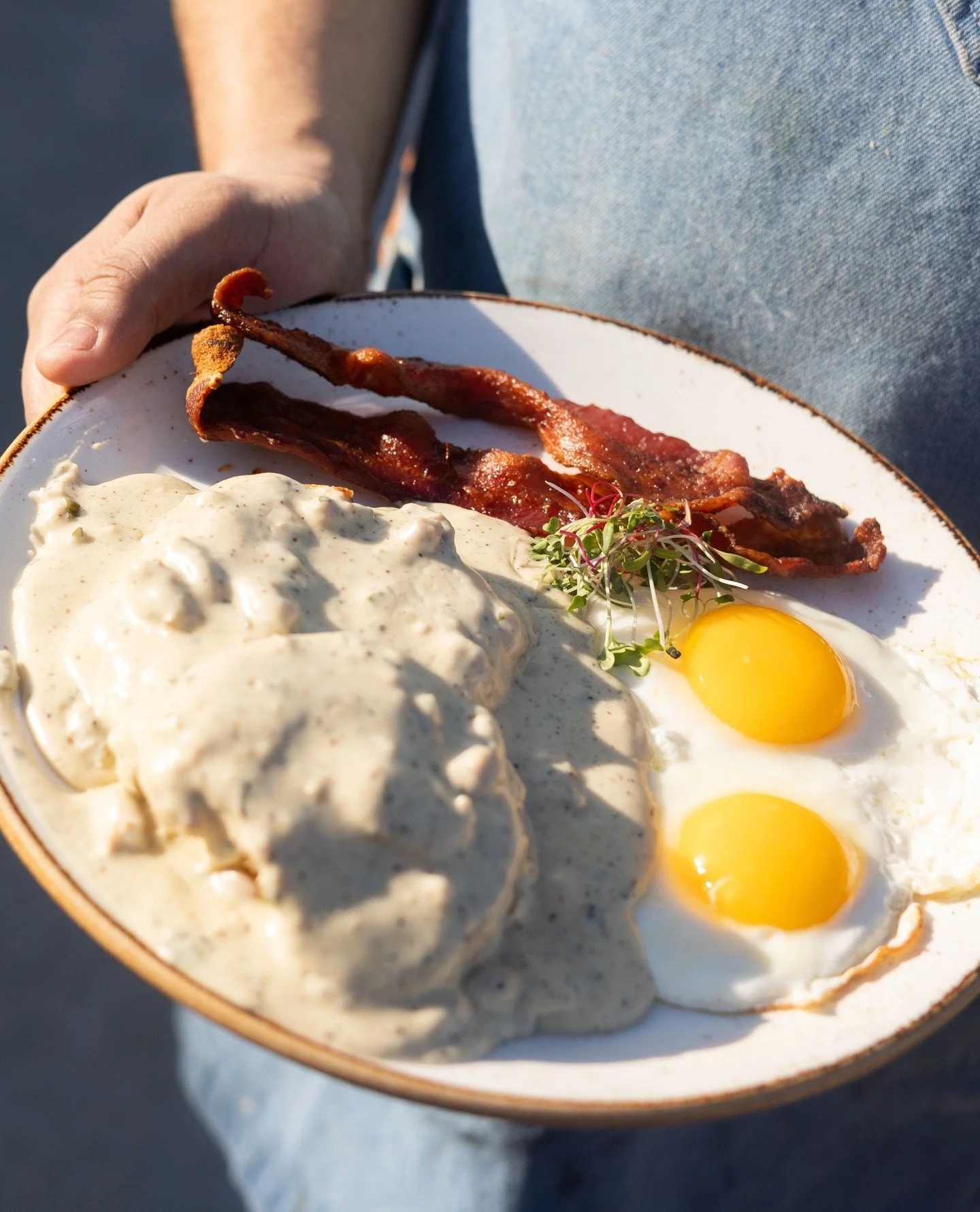 Sometimes all you need is a classic, comfort food to start your weekend. For us, that's Farm 12's biscuits and gravy!🍳⁠
⁠
Housemade sausage gravy on a fluffy Macrina bakery biscuit, paired with two farm eggs any style, and your choice of bacon or sa