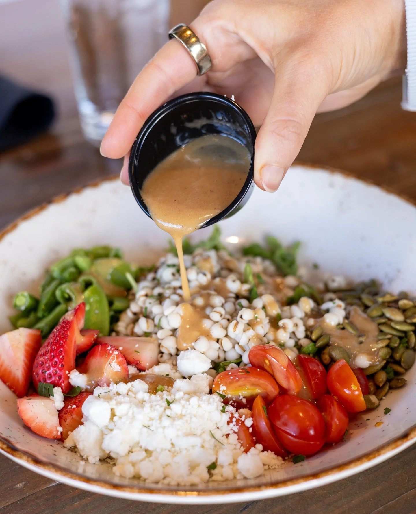 Our new Grain Bowl is the perfect fresh summer lunch for our upcoming patio season 🍓⁠
⁠
Made with Job&rsquo;s tears, arugula, snap peas, strawberries, grape tomatoes, goat cheese, toasted pepitas, and topped with our house sweet onion vinaigrette! ⁠