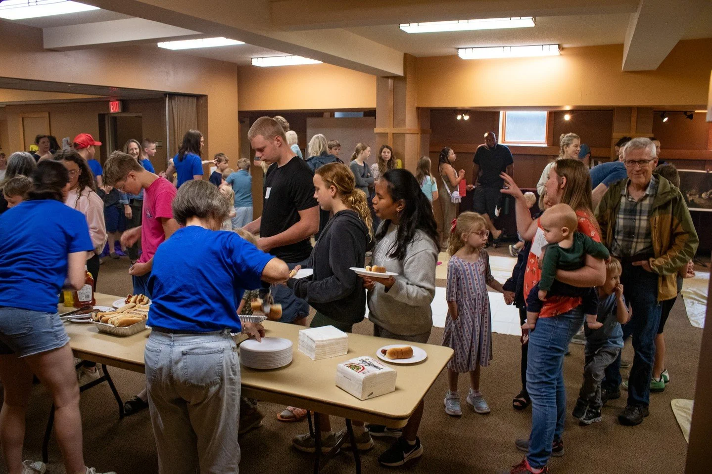 VBS Part 3/3: Our last day got a little rained out, but that didn't stop us from sharing our traditional family meal in the Great Hall to cap off the week together! 🌭⁠
⁠
We're so grateful for all our volunteers in blue shirts who helped pivot our pl