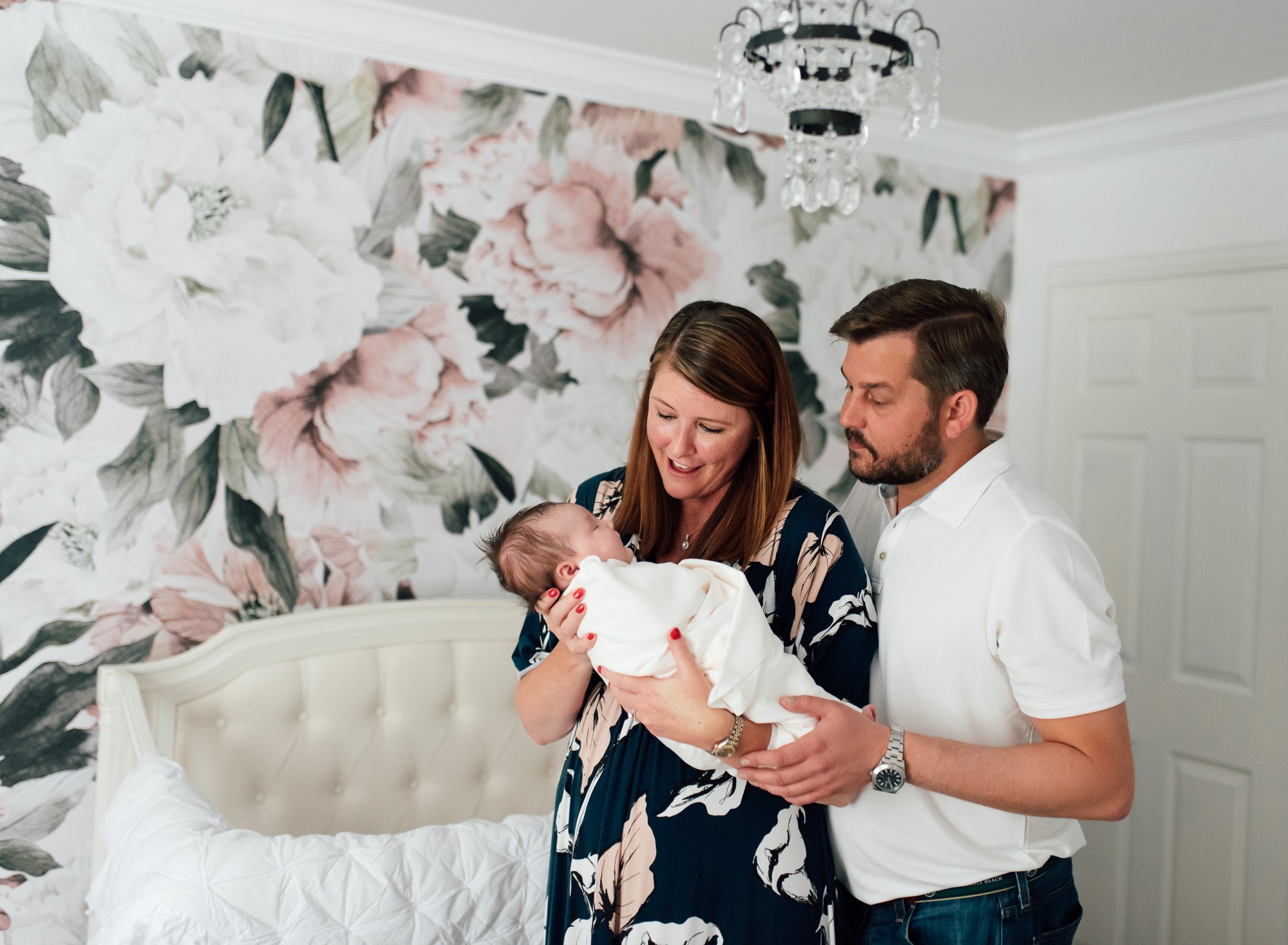 parents with newborn in nursery St. Louis Newborn Photography sarahrowlandphotography.com