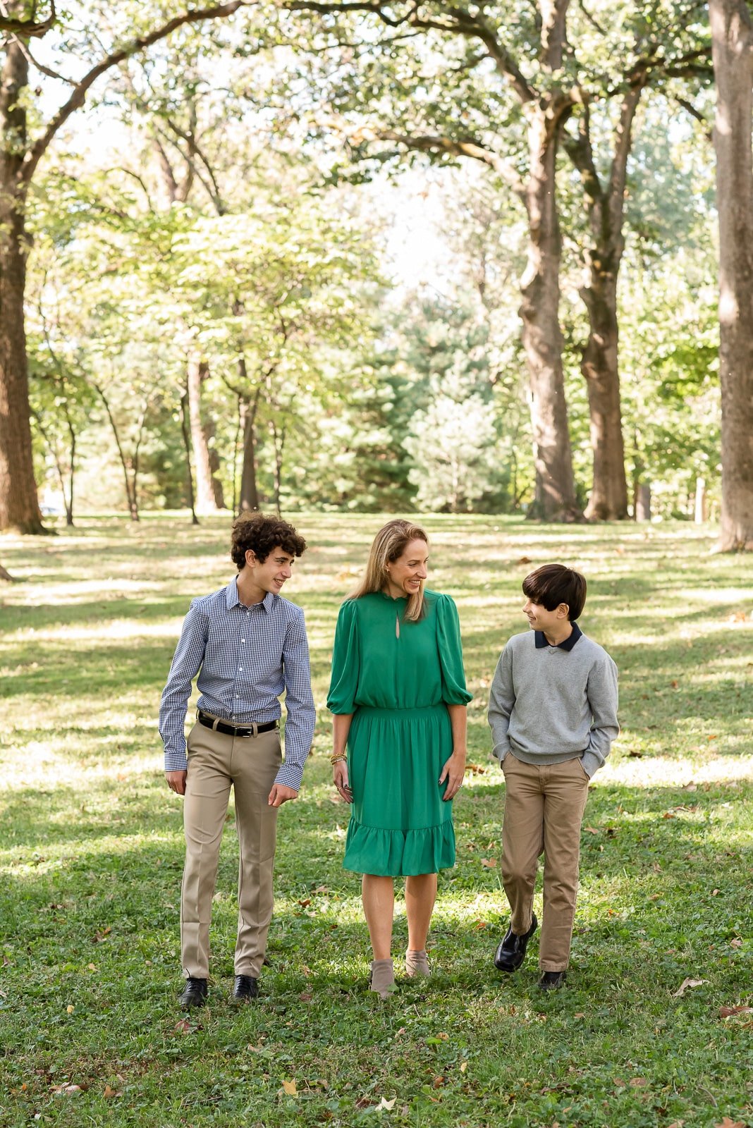 mom walking with sons in park  St. Louis Family Photography sarahrowlandphotography.com