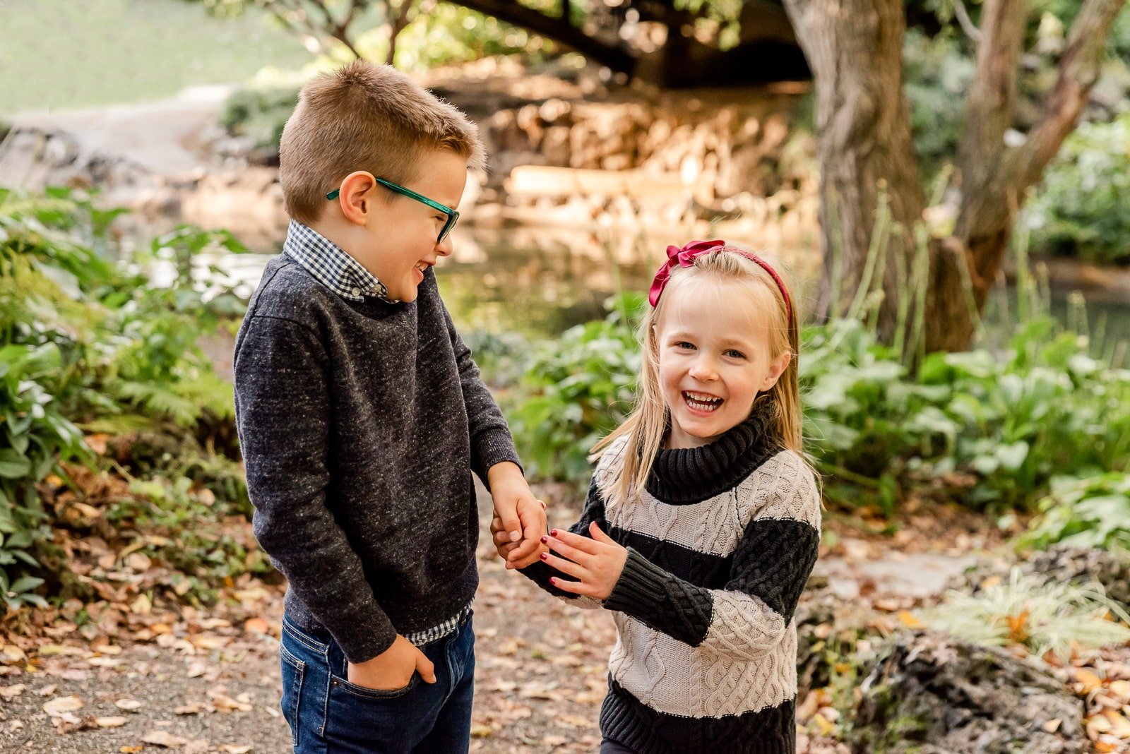 siblings laughing by pond  St. Louis Family Photography sarahrowlandphotography.com