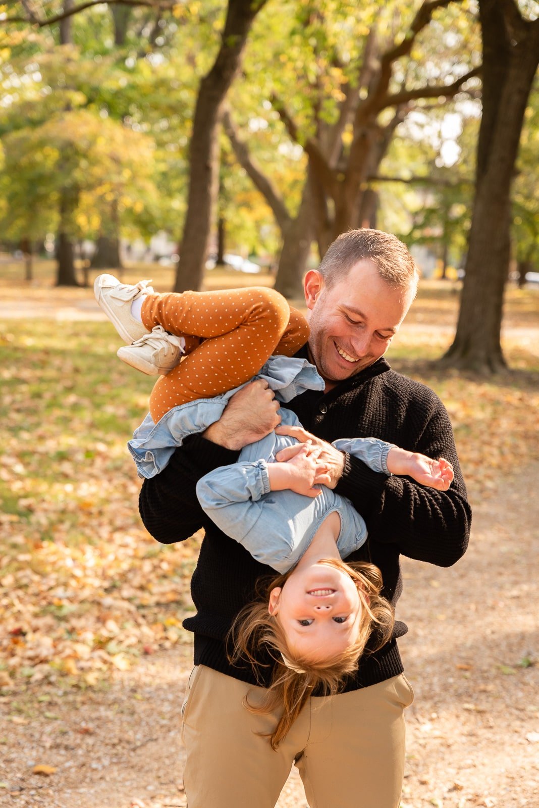 father holding daughter upside down  St. Louis Family Photography sarahrowlandphotography.com