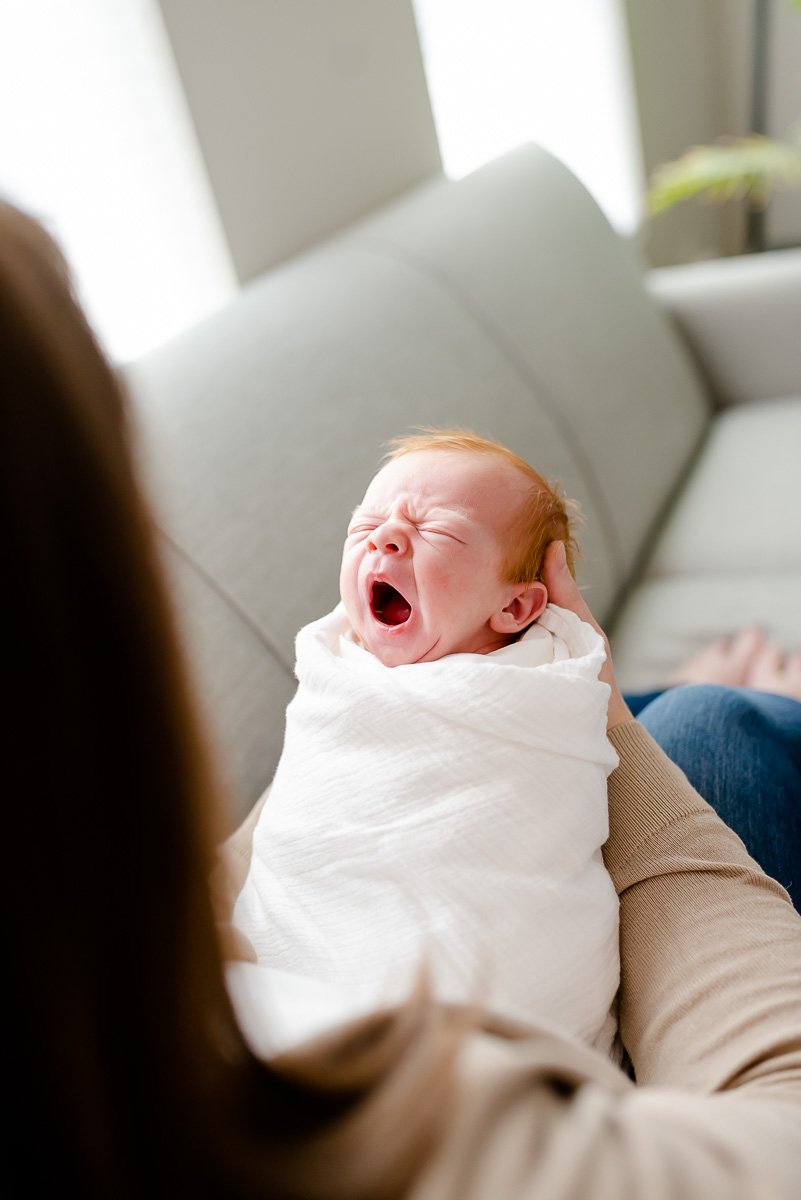 yawning newborn baby with red hair  St. Louis Newborn Photography sarahrowlandphotography.com