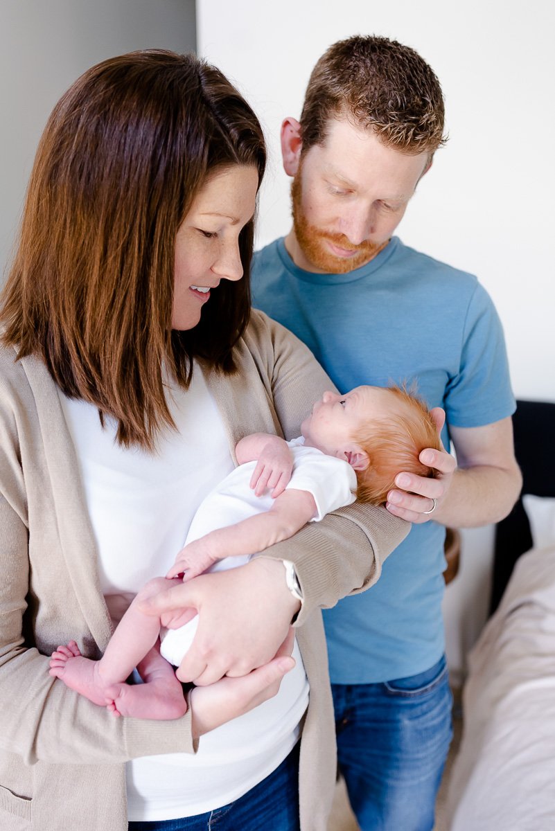 parents holding newborn baby  St. Louis Newborn Photography sarahrowlandphotography.com