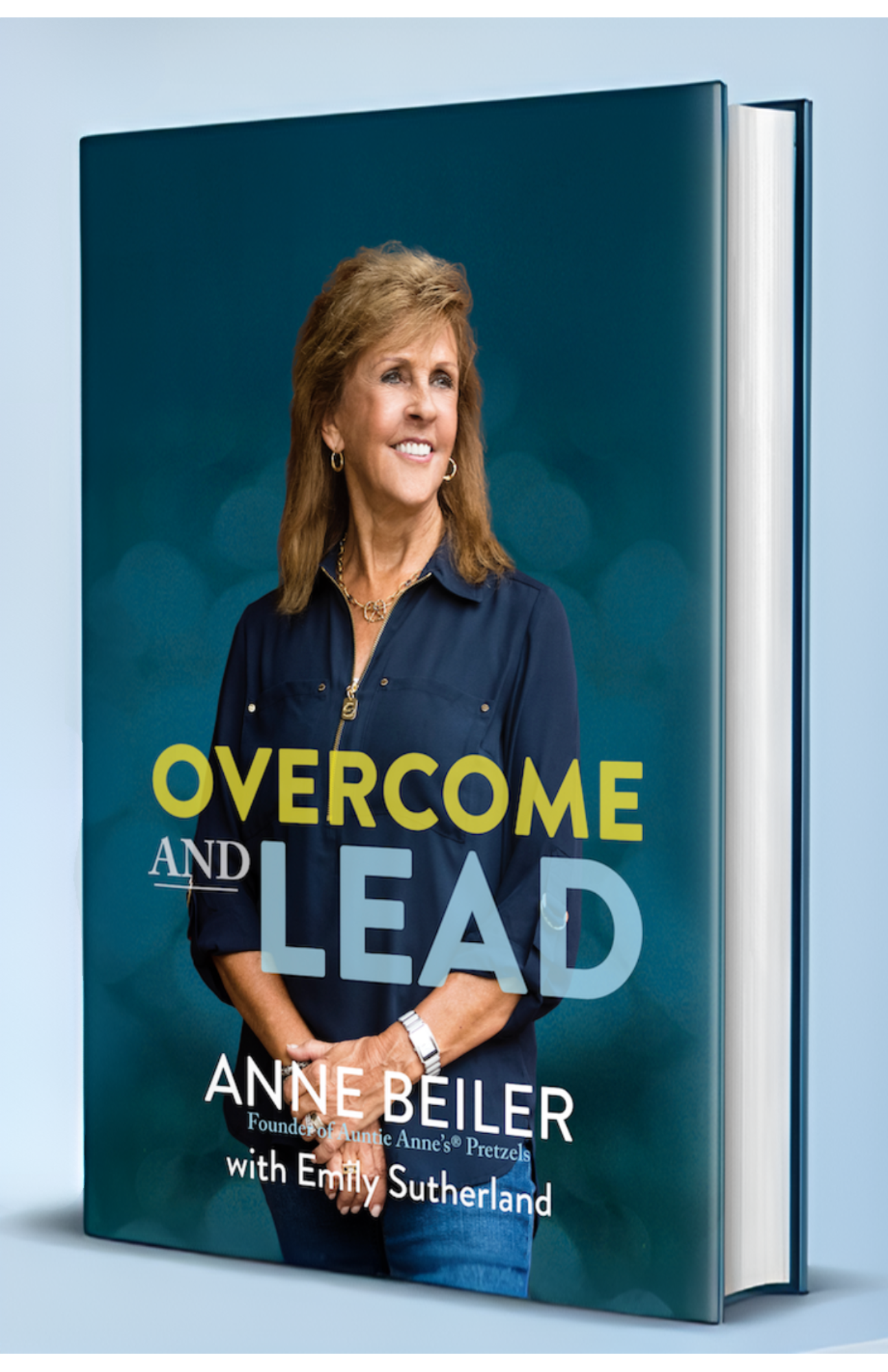 Book cover with a smiling woman wearing a navy blue shirt, titled 'Overcome and Lead' by Anne Beiler with Emily Sutherland.