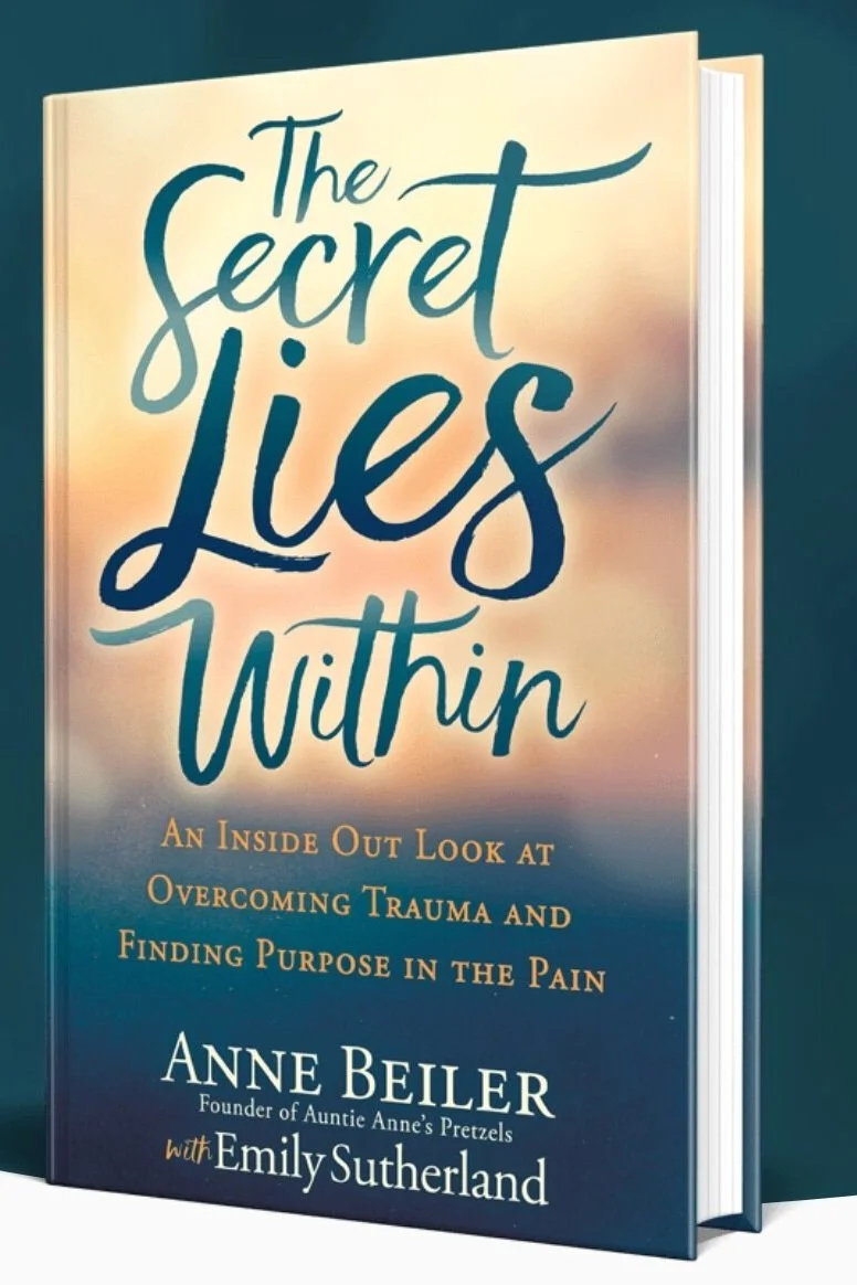 Book cover titled "The Secret Lies Within" by Anne Beiler with Emily Sutherland, with a subtitle about overcoming trauma and finding purpose in pain.