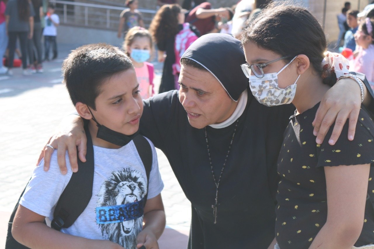    Sr. Nabila with pupils on the schoolyard - at the Rosary Sisters School of Gaza.    