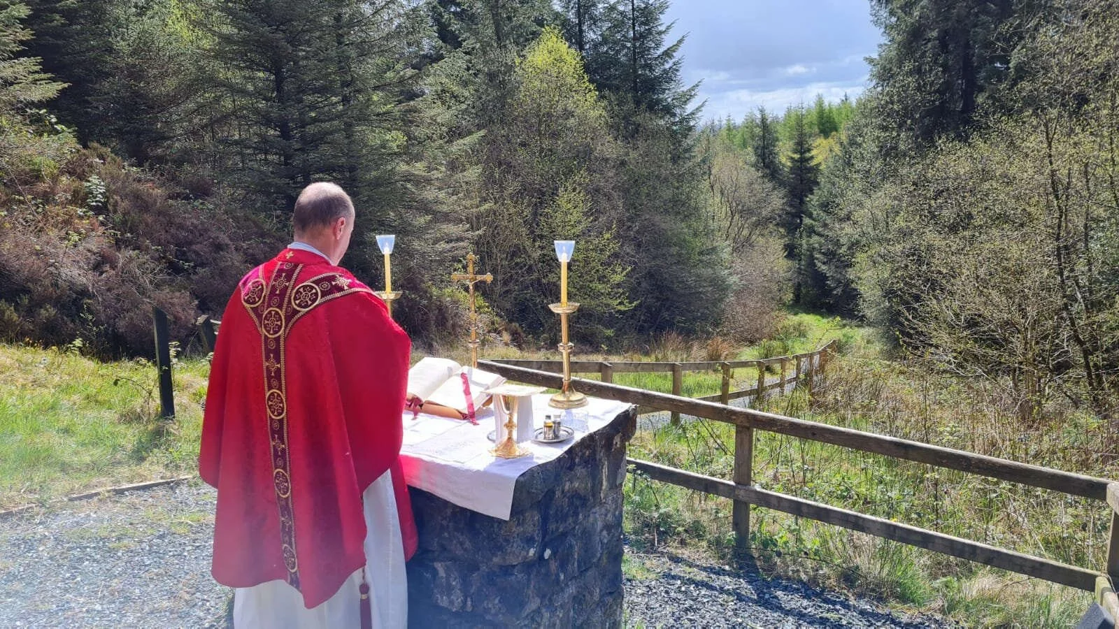 Fr Sean Mulligan celebrates Mass overlooking a wooded valley