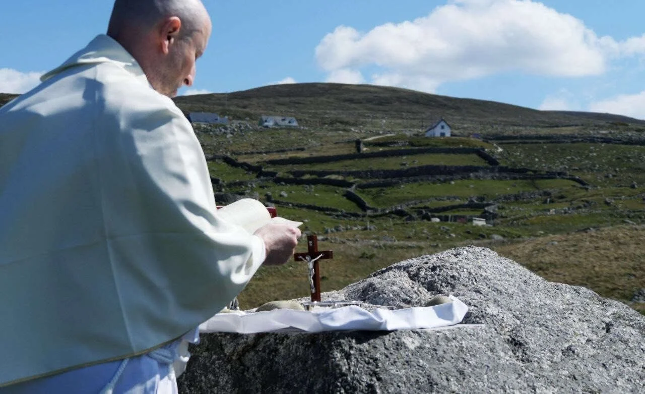 Fr Shane celebrates Mass at a coastal rock altar