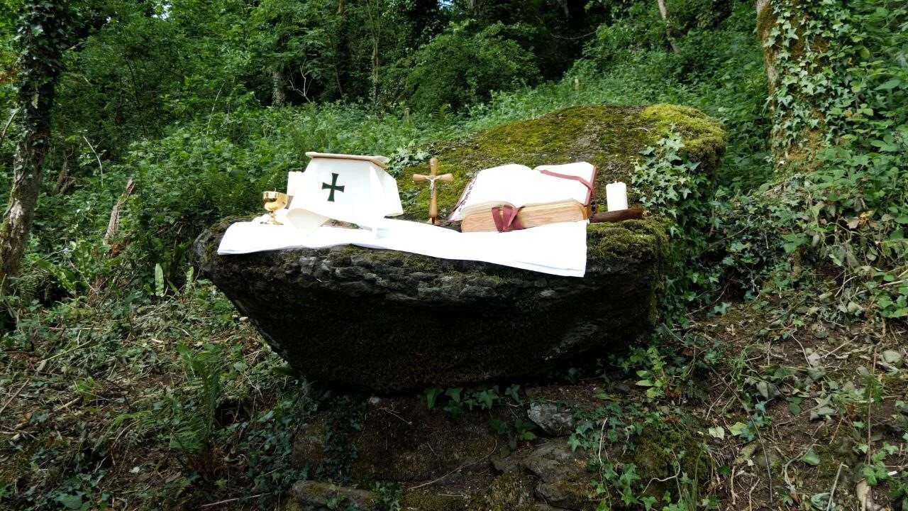 Woodland Mass Rock altar with a missal and crucifix