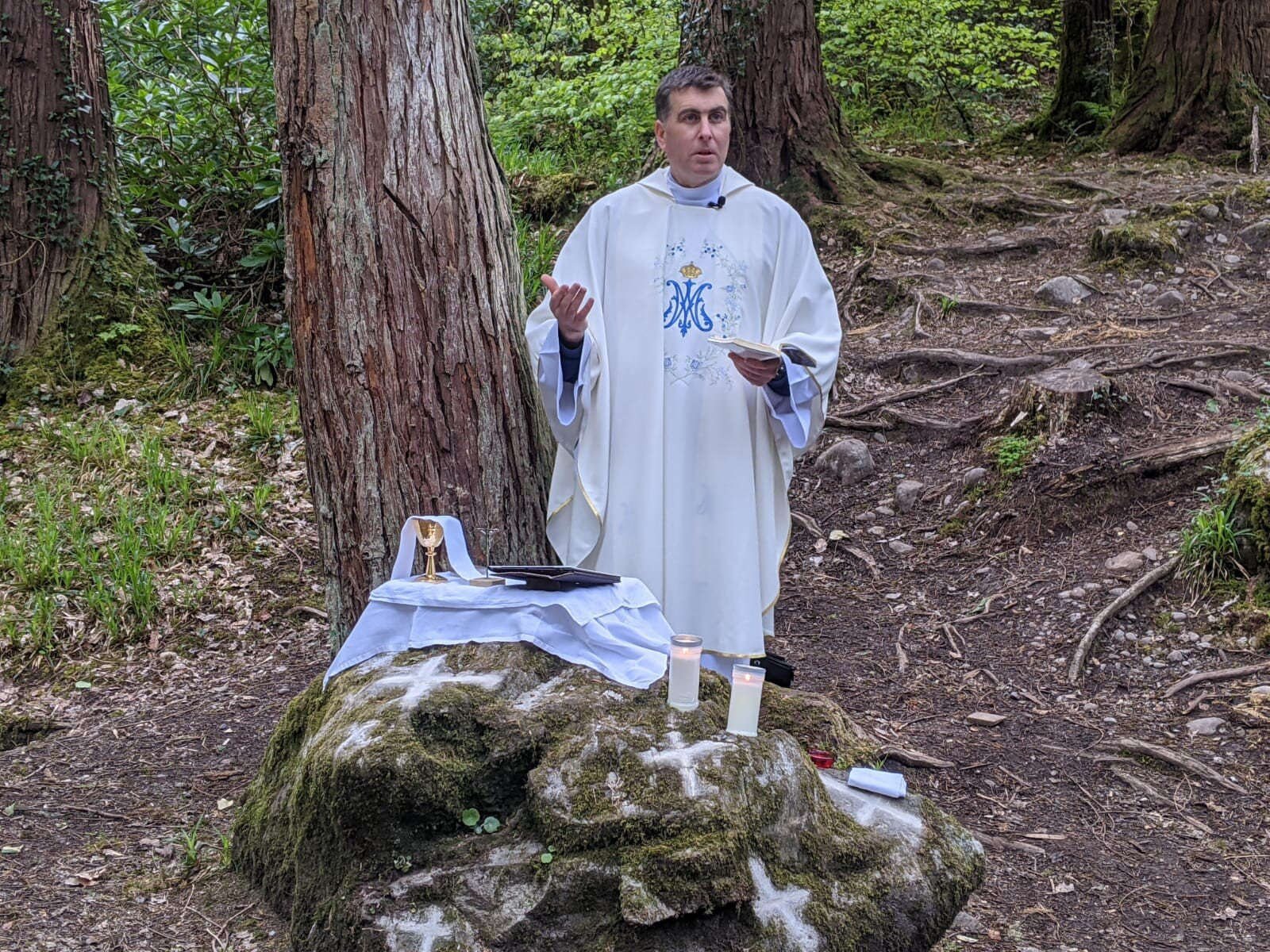 A priest addresses worshippers at Pike Wood Mass Rock