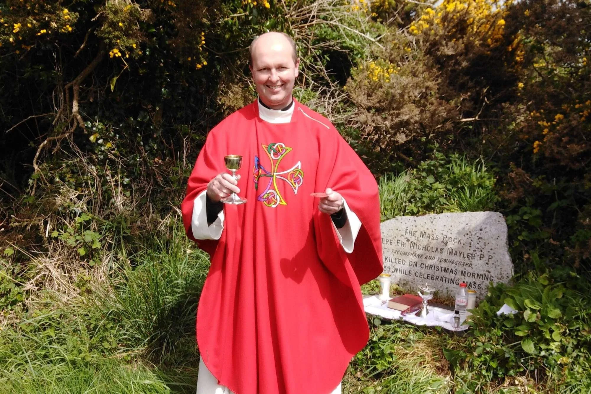 Fr Jim Doyle addresses worshippers at Tomhaggard Mass Rock